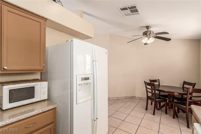 8041 Astrology Ct Unit 201, Las Vegas, NV 89128 - kitchen with white appliances, light tile patterned floors, a ceiling fan, and light countertops
