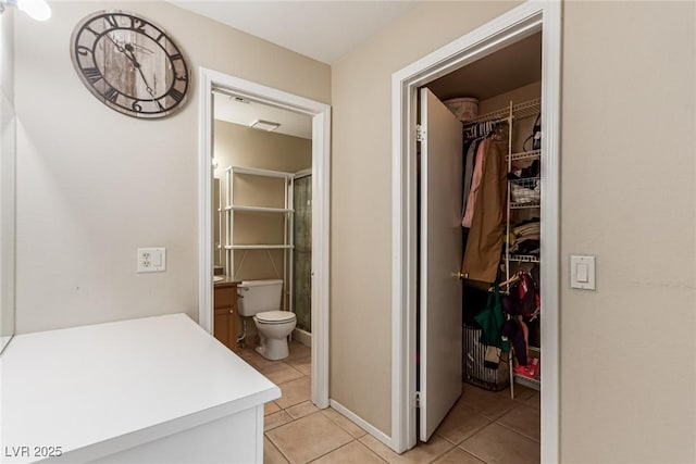 8041 Astrology Ct Unit 201, Las Vegas, NV 89128 - bathroom with tile patterned flooring, a spacious closet, a shower, and vanity