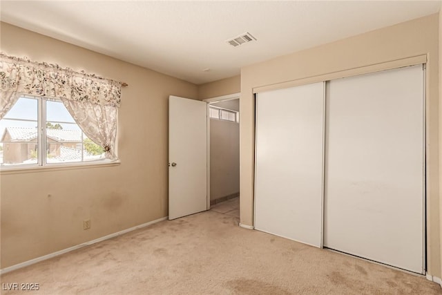 8041 Astrology Ct Unit 201, Las Vegas, NV 89128 - unfurnished bedroom with light colored carpet and a closet