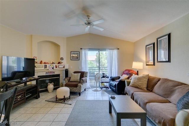 5415 W Harmon Ave Unit 2075, Las Vegas, NV 89103 - living area with lofted ceiling, a ceiling fan, light tile patterned floors, and a tile fireplace