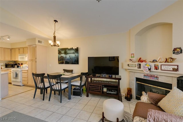 5415 W Harmon Ave Unit 2075, Las Vegas, NV 89103 - dining area with a chandelier, light tile patterned floors, and a fireplace