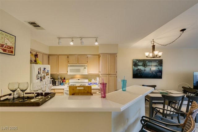 5415 W Harmon Ave Unit 2075, Las Vegas, NV 89103 - kitchen with white appliances, a chandelier, a peninsula, light countertops, and light brown cabinets