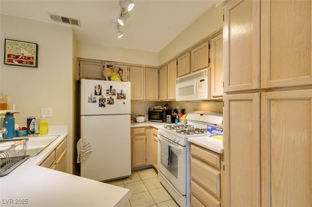 5415 W Harmon Ave Unit 2075, Las Vegas, NV 89103 - kitchen featuring white appliances, light brown cabinetry, light tile patterned floors, and light countertops