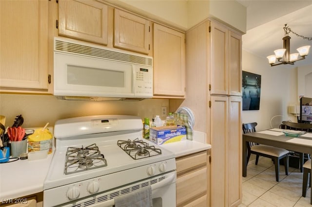 5415 W Harmon Ave Unit 2075, Las Vegas, NV 89103 - kitchen with white appliances, light countertops, light brown cabinetry, and a chandelier