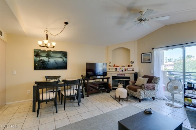 5415 W Harmon Ave Unit 2075, Las Vegas, NV 89103 - living area featuring light tile patterned floors, ceiling fan, a chandelier, vaulted ceiling, and a tiled fireplace