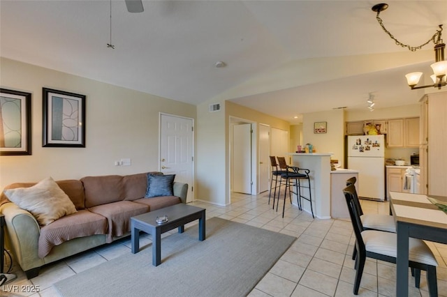5415 W Harmon Ave Unit 2075, Las Vegas, NV 89103 - living area with lofted ceiling, light tile patterned floors, and a chandelier