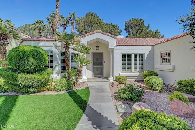 5224 Painted Lakes Way, Las Vegas, NV 89149 - mediterranean / spanish-style home featuring a tiled roof, stucco siding, and a front yard