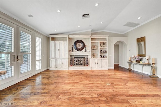 5224 Painted Lakes Way, Las Vegas, NV 89149 - living area with ornamental molding, arched walkways, light wood-style floors, vaulted ceiling, and recessed lighting