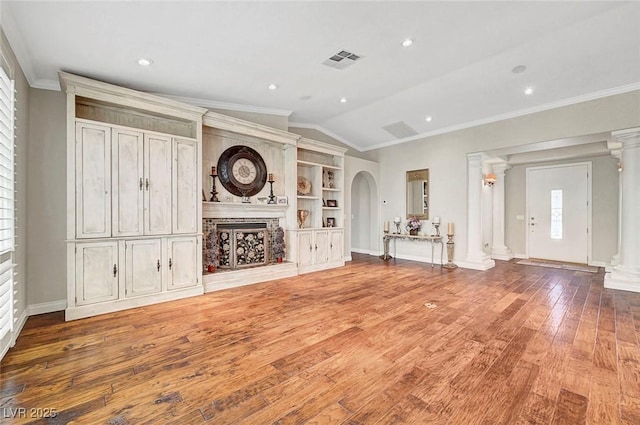5224 Painted Lakes Way, Las Vegas, NV 89149 - unfurnished living room with ornate columns, lofted ceiling, wood finished floors, ornamental molding, and a fireplace