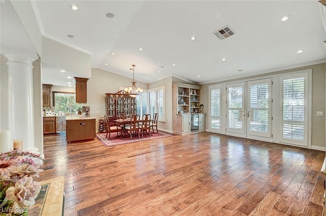 5224 Painted Lakes Way, Las Vegas, NV 89149 - dining space with ornamental molding, light wood-type flooring, a chandelier, wine cooler, and french doors