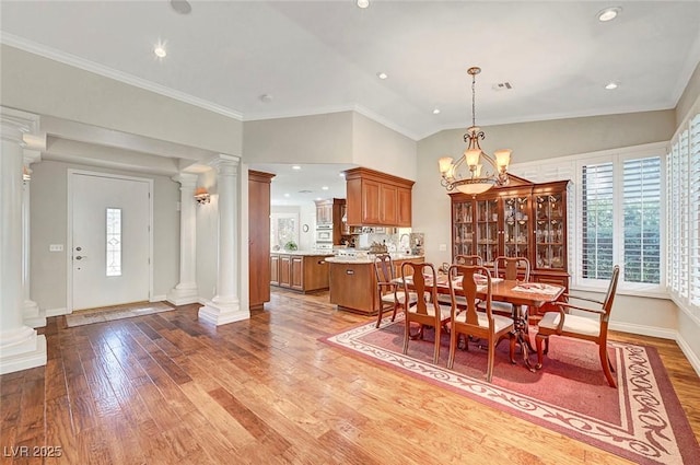 5224 Painted Lakes Way, Las Vegas, NV 89149 - dining room featuring ornate columns, wood-type flooring, ornamental molding, a chandelier, and recessed lighting