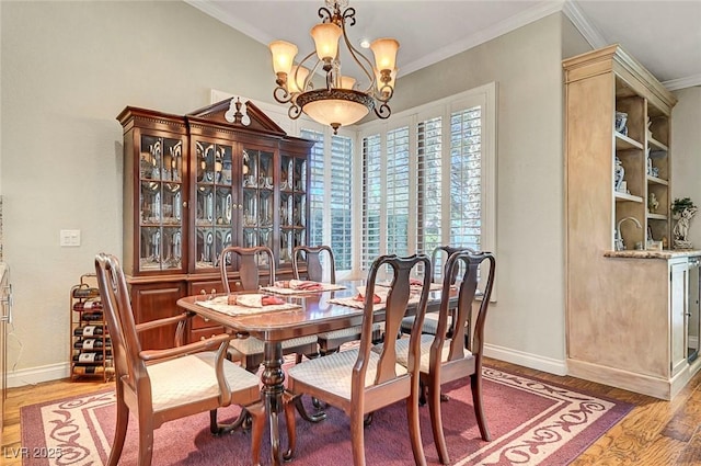 5224 Painted Lakes Way, Las Vegas, NV 89149 - dining area with light wood finished floors, crown molding, and a chandelier