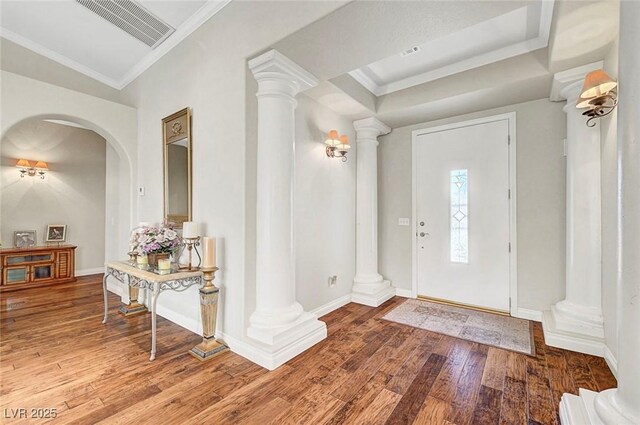 5224 Painted Lakes Way, Las Vegas, NV 89149 - foyer entrance with ornate columns, wood finished floors, crown molding, and arched walkways