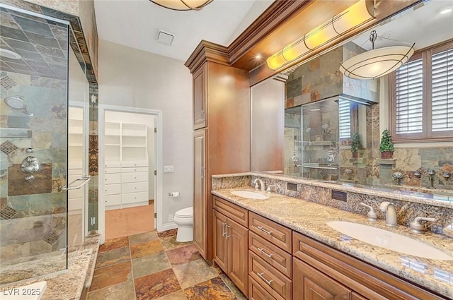 5224 Painted Lakes Way, Las Vegas, NV 89149 - full bathroom with a shower stall, double vanity, stone tile floors, and a closet