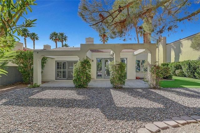 5224 Painted Lakes Way, Las Vegas, NV 89149 - back of property featuring french doors, stucco siding, a chimney, and a patio area