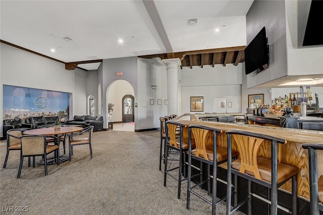 5224 Painted Lakes Way, Las Vegas, NV 89149 - dining space with ornate columns, a towering ceiling, carpet floors, beam ceiling, and arched walkways
