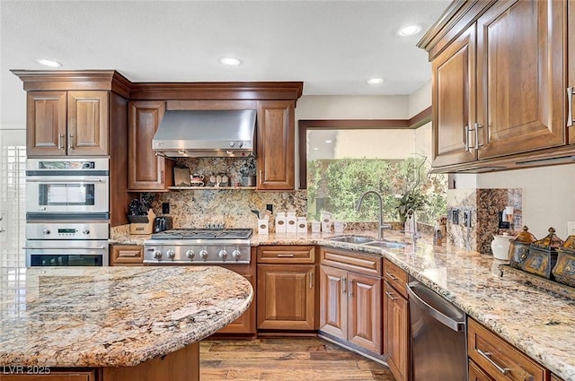 5224 Painted Lakes Way, Las Vegas, NV 89149 - kitchen with wall chimney range hood, stainless steel appliances, light stone counters, and recessed lighting