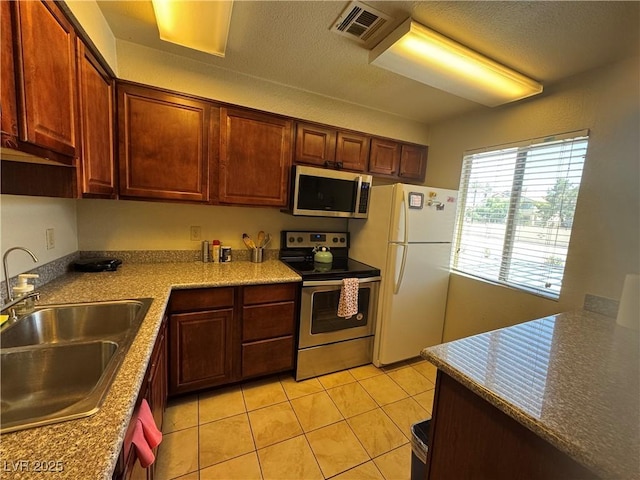 5499 Indian River Dr Unit 356, Las Vegas, NV 89103 - kitchen with appliances with stainless steel finishes and light tile patterned flooring