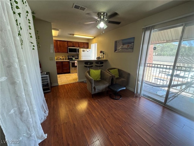 5499 Indian River Dr Unit 356, Las Vegas, NV 89103 - living area with wood finished floors and a ceiling fan