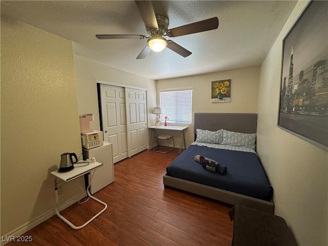 5499 Indian River Dr Unit 356, Las Vegas, NV 89103 - bedroom with wood finished floors, a textured wall, a textured ceiling, a closet, and a ceiling fan
