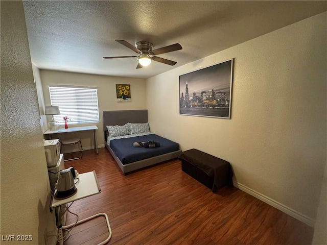 5499 Indian River Dr Unit 356, Las Vegas, NV 89103 - bedroom featuring wood finished floors, ceiling fan, a textured wall, and a textured ceiling