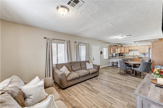 744 Mcknight St, Las Vegas, NV 89101 - living room with light wood-style floors and a textured ceiling