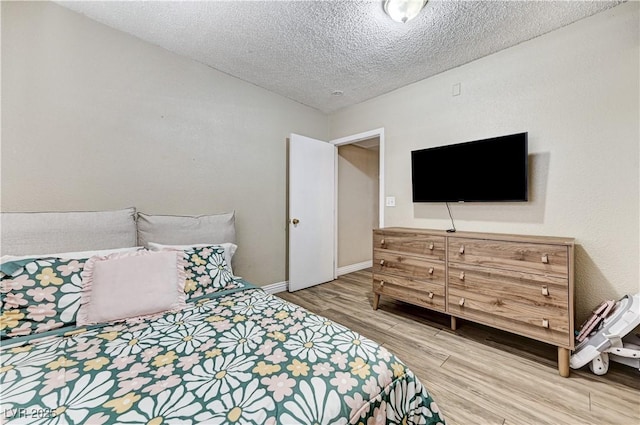 744 Mcknight St, Las Vegas, NV 89101 - bedroom with light wood finished floors and a textured ceiling