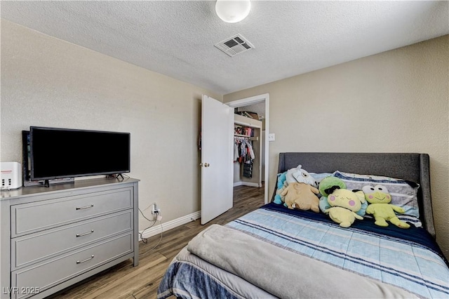 744 Mcknight St, Las Vegas, NV 89101 - bedroom with light wood-style floors and a textured ceiling