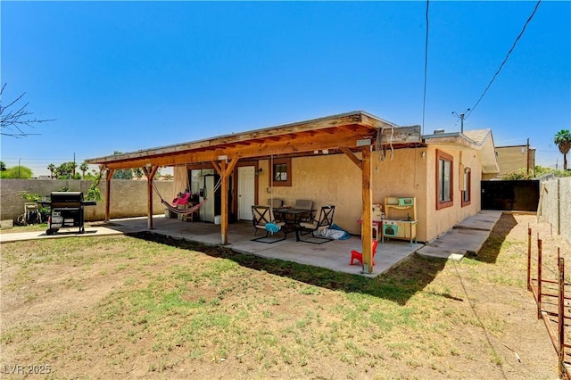 744 Mcknight St, Las Vegas, NV 89101 - back of property with a fenced backyard, a patio, and stucco siding