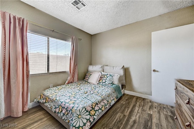 744 Mcknight St, Las Vegas, NV 89101 - bedroom featuring wood finished floors, a textured ceiling, and a textured wall