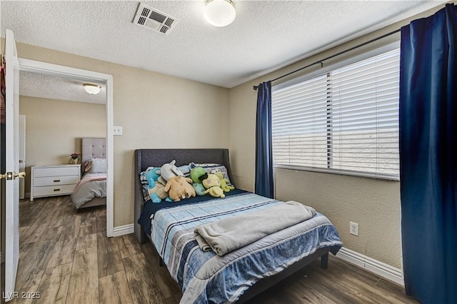 744 Mcknight St, Las Vegas, NV 89101 - bedroom with wood finished floors and a textured ceiling