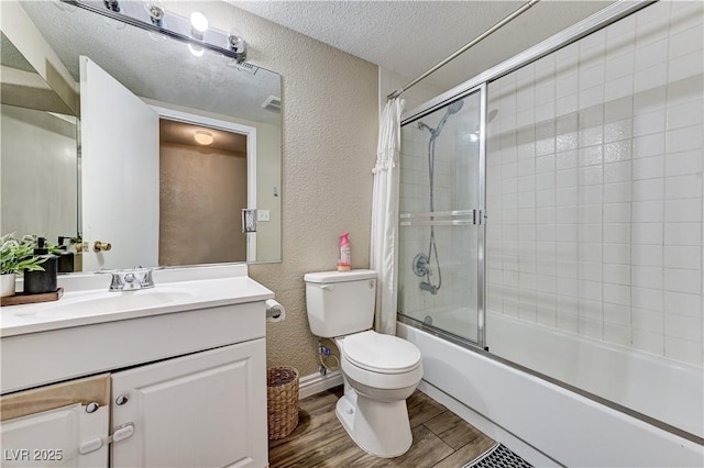 744 Mcknight St, Las Vegas, NV 89101 - bathroom featuring a textured wall, vanity, shower / bath combination with glass door, wood finished floors, and a textured ceiling