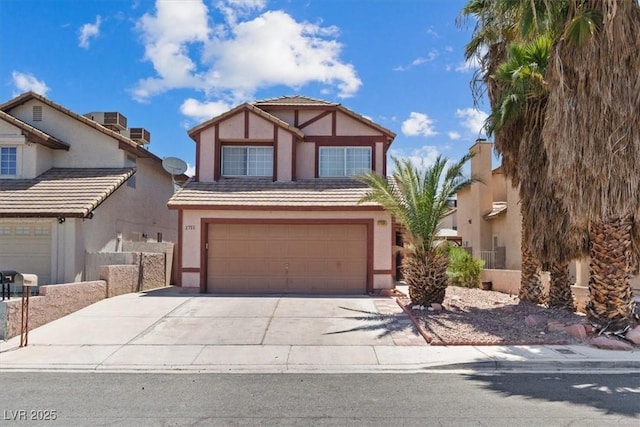 1711 Ember Glow Cir, Las Vegas, NV 89119 - tudor home with stucco siding, an attached garage, and driveway