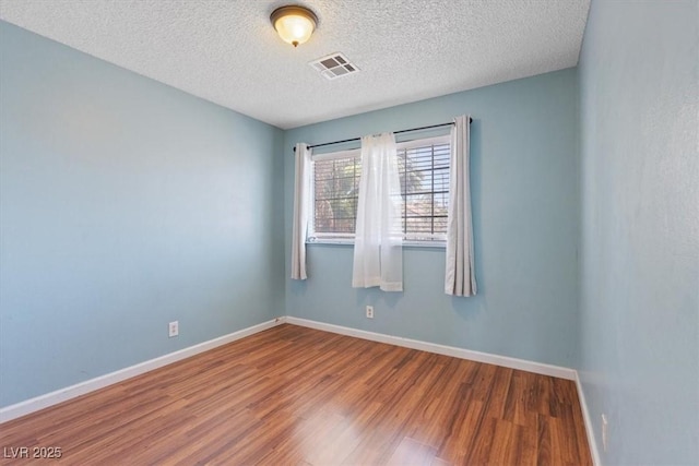 1711 Ember Glow Cir, Las Vegas, NV 89119 - spare room featuring wood finished floors and a textured ceiling