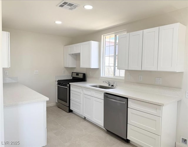 236 Pershing Dr, Las Vegas, NV 89107 - kitchen with stainless steel appliances, white cabinetry, light countertops, and recessed lighting