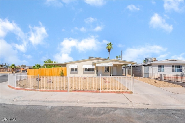 600 Berry Cir, Las Vegas, NV 89107 - view of front of house featuring a fenced front yard, driveway, and an attached carport