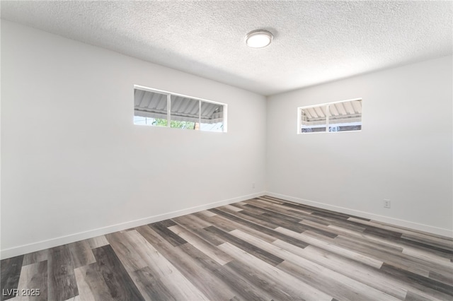 600 Berry Cir, Las Vegas, NV 89107 - empty room with wood finished floors and a textured ceiling