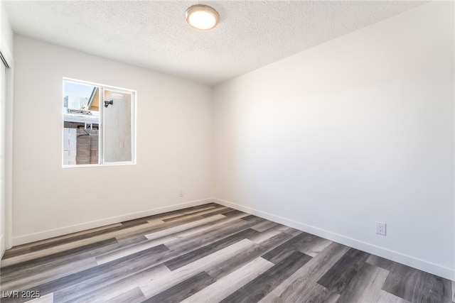 600 Berry Cir, Las Vegas, NV 89107 - spare room featuring dark wood-style floors and a textured ceiling