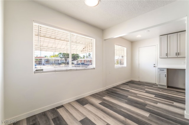 600 Berry Cir, Las Vegas, NV 89107 - unfurnished dining area featuring wood finished floors, a textured ceiling, and recessed lighting