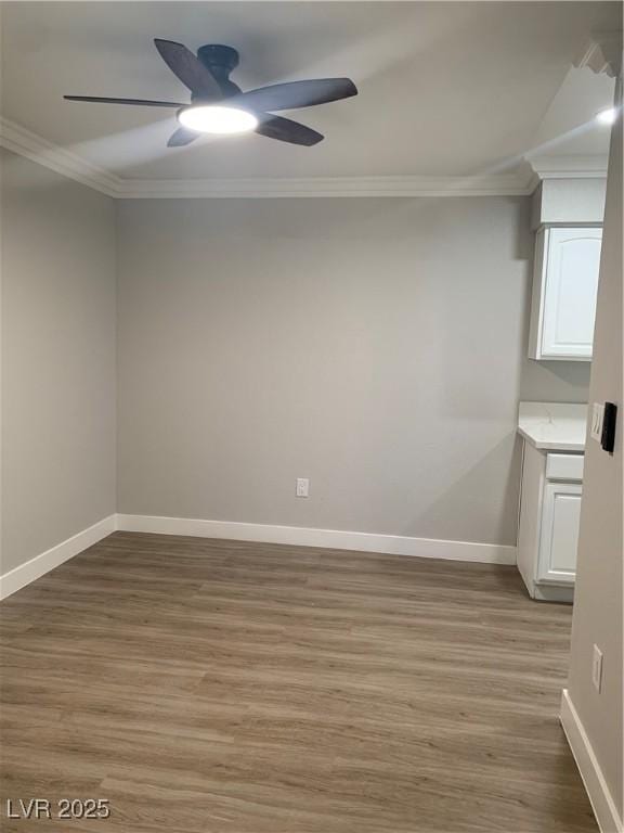 8101 W Flamingo Rd Unit 1102, Las Vegas, NV 89147 - empty room with ornamental molding, ceiling fan, and light wood-type flooring