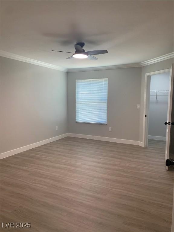 8101 W Flamingo Rd Unit 1102, Las Vegas, NV 89147 - spare room with ornamental molding, wood finished floors, and a ceiling fan