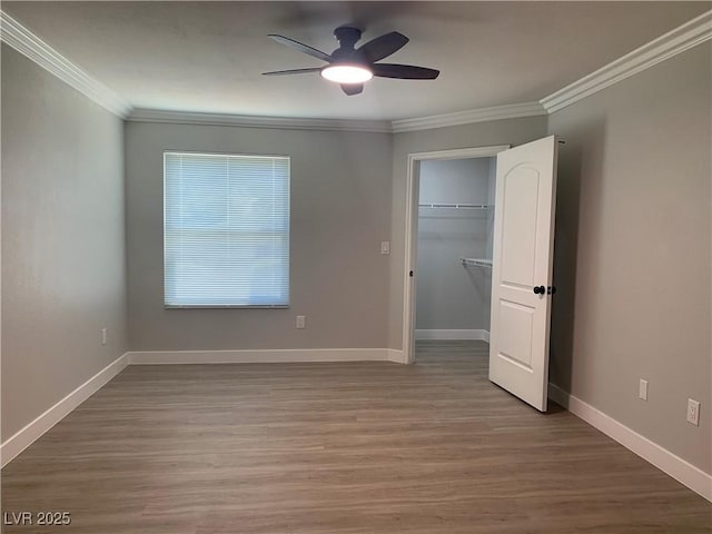 8101 W Flamingo Rd Unit 1102, Las Vegas, NV 89147 - unfurnished bedroom with crown molding, wood finished floors, a spacious closet, ceiling fan, and a closet