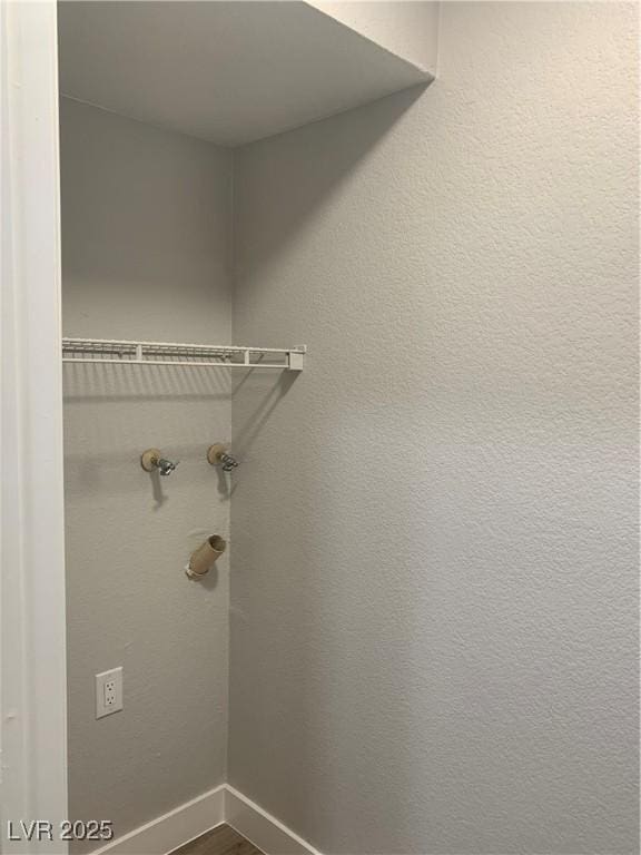 8101 W Flamingo Rd Unit 1102, Las Vegas, NV 89147 - laundry area featuring dark wood-style floors and baseboards