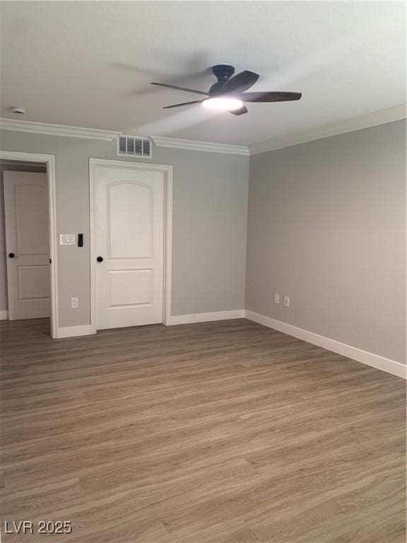 8101 W Flamingo Rd Unit 1102, Las Vegas, NV 89147 - empty room featuring crown molding, a ceiling fan, light wood-type flooring, and a smoke detector