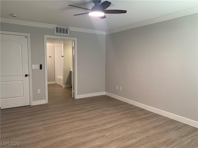 8101 W Flamingo Rd Unit 1102, Las Vegas, NV 89147 - spare room featuring a ceiling fan, light wood-style floors, crown molding, and a smoke detector