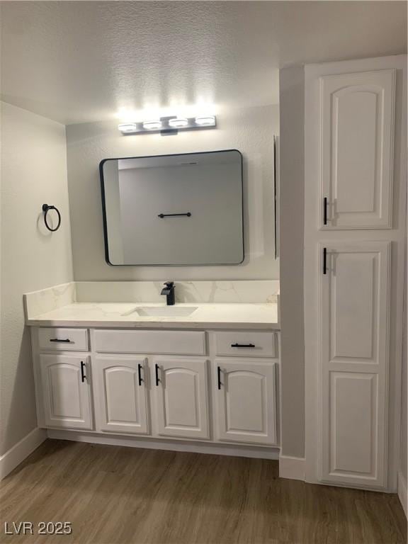 8101 W Flamingo Rd Unit 1102, Las Vegas, NV 89147 - bathroom with wood finished floors and vanity