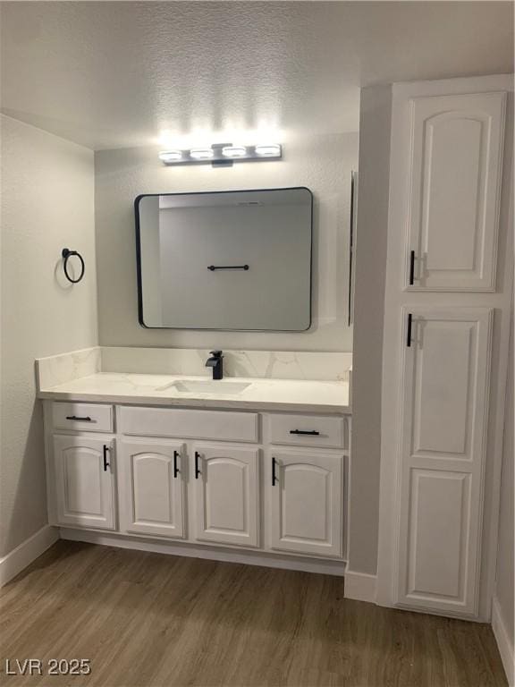 8101 W Flamingo Rd Unit 1102, Las Vegas, NV 89147 - bathroom featuring wood finished floors and vanity