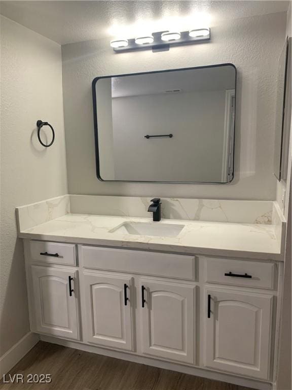 8101 W Flamingo Rd Unit 1102, Las Vegas, NV 89147 - bathroom featuring vanity and wood finished floors