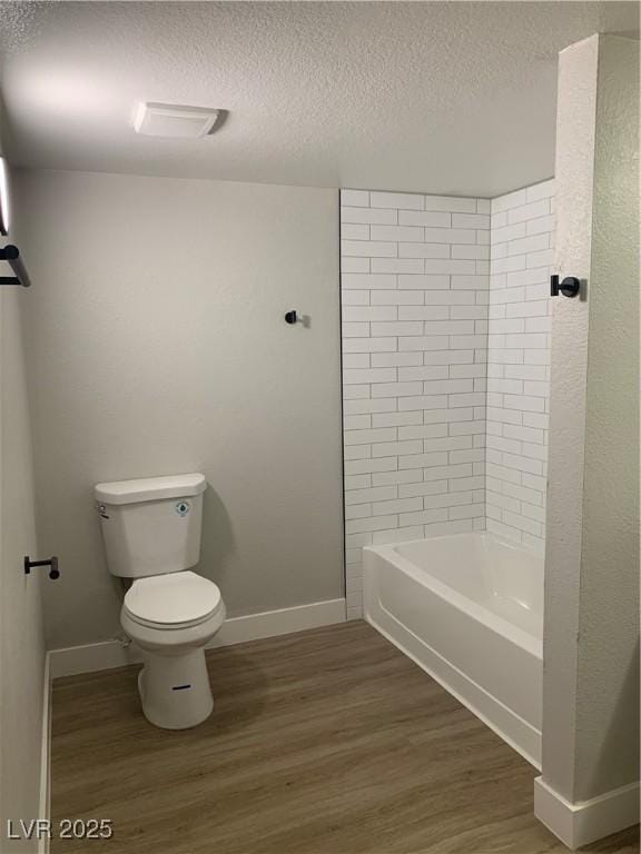 8101 W Flamingo Rd Unit 1102, Las Vegas, NV 89147 - bathroom with a textured ceiling, wood finished floors, and tub / shower combination