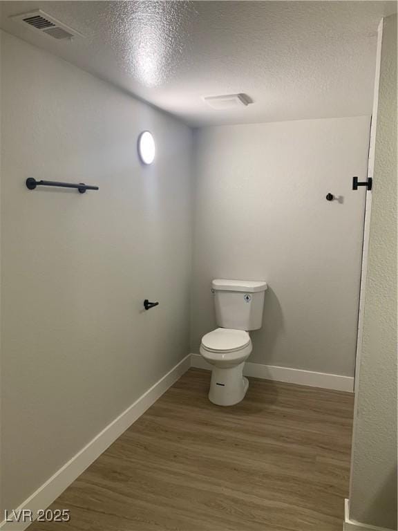 8101 W Flamingo Rd Unit 1102, Las Vegas, NV 89147 - bathroom featuring a textured ceiling and wood finished floors